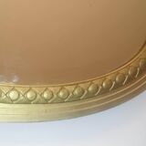 Oval mirror in wood and gilded plaster with pompom decoration