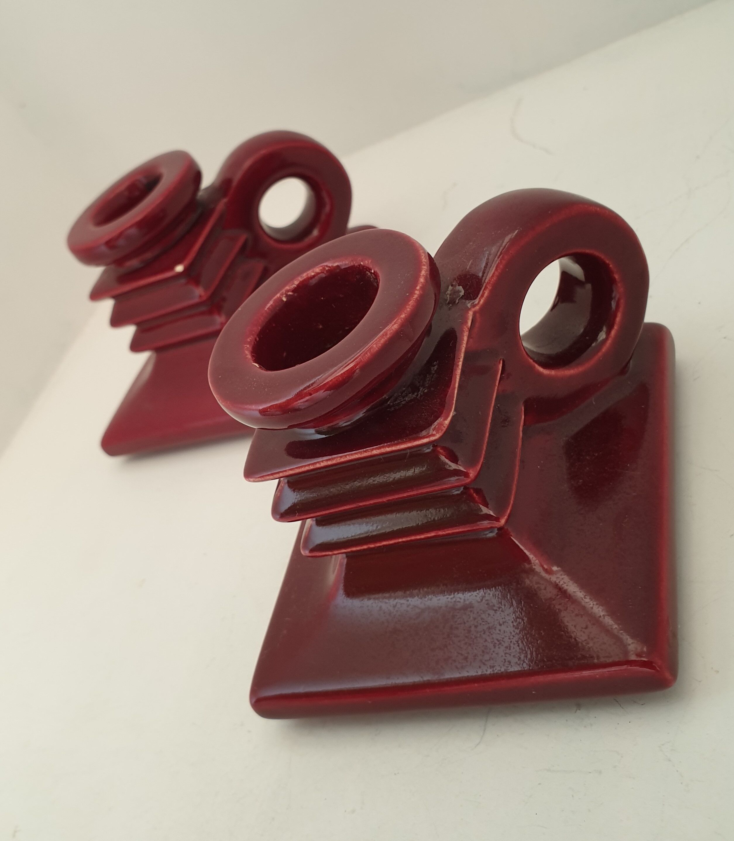 Pair of art deco candlesticks in bordeaux ceramics