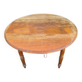 Antique drop-leaf table in wood, with turned legs and castors.