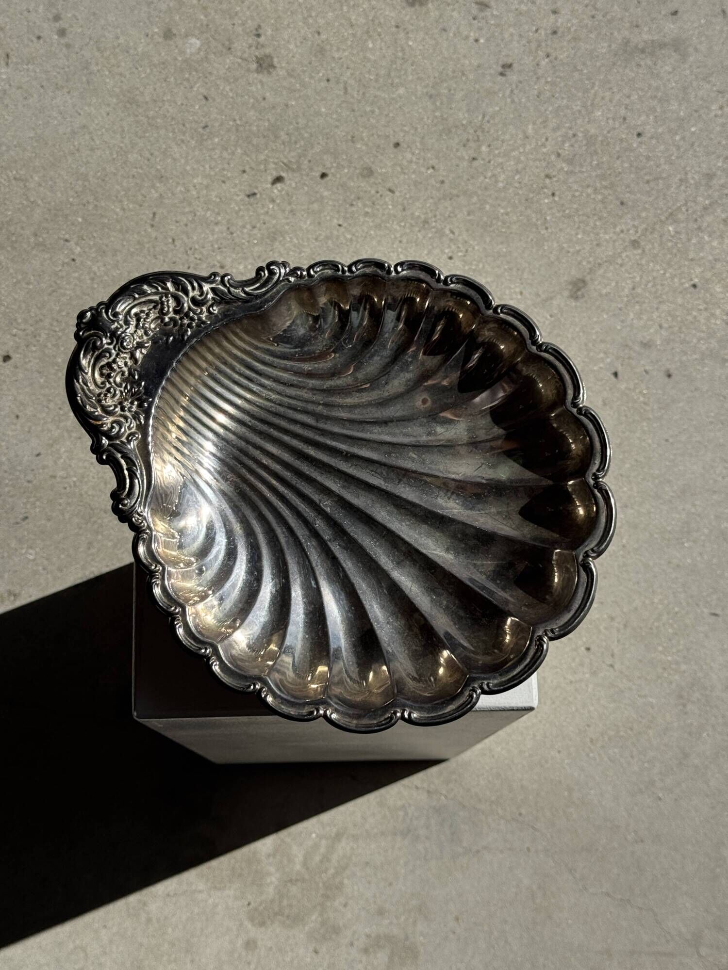 Large antique silver-plated bowl in the shape of a shell.