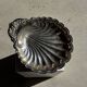 Large antique silver-plated bowl in the shape of a shell.