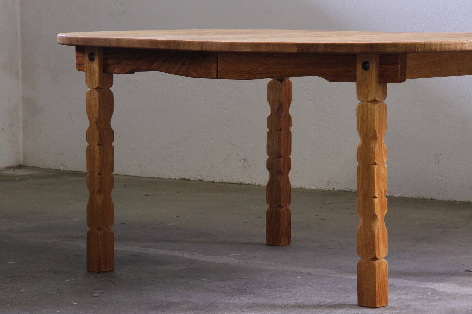 Vintage Danish brutalist oval extendable oak dining table in the style of Henning Kjærnulf, 1960s