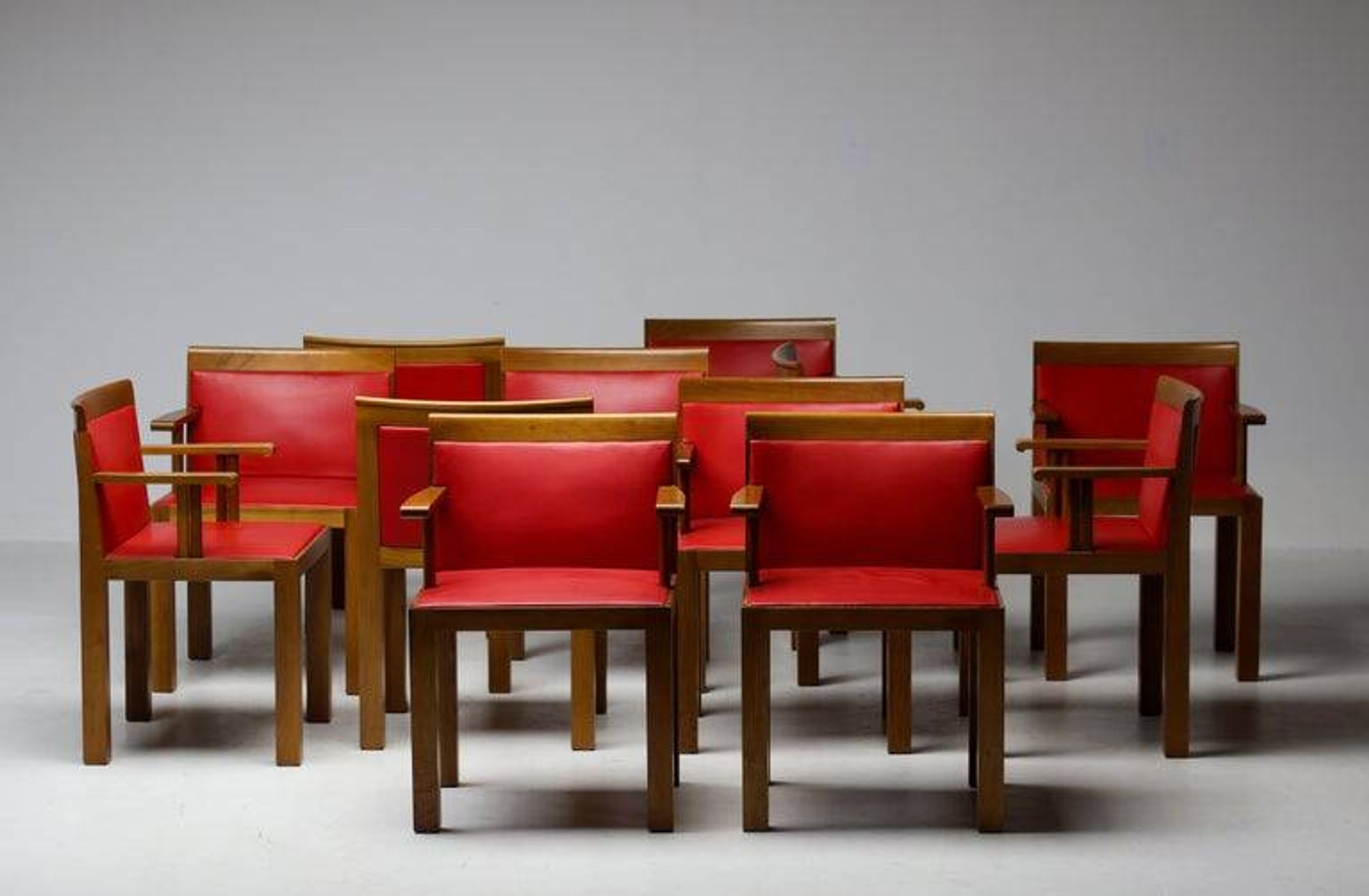 A masterpiece of Italian modernism: eleven Aldo Rossi red Teatro arm chairs