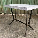 Vintage bistro table with an Art Deco style cast iron base and Formica top.