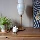 Mid-century gold metal table lamp with white striped shade