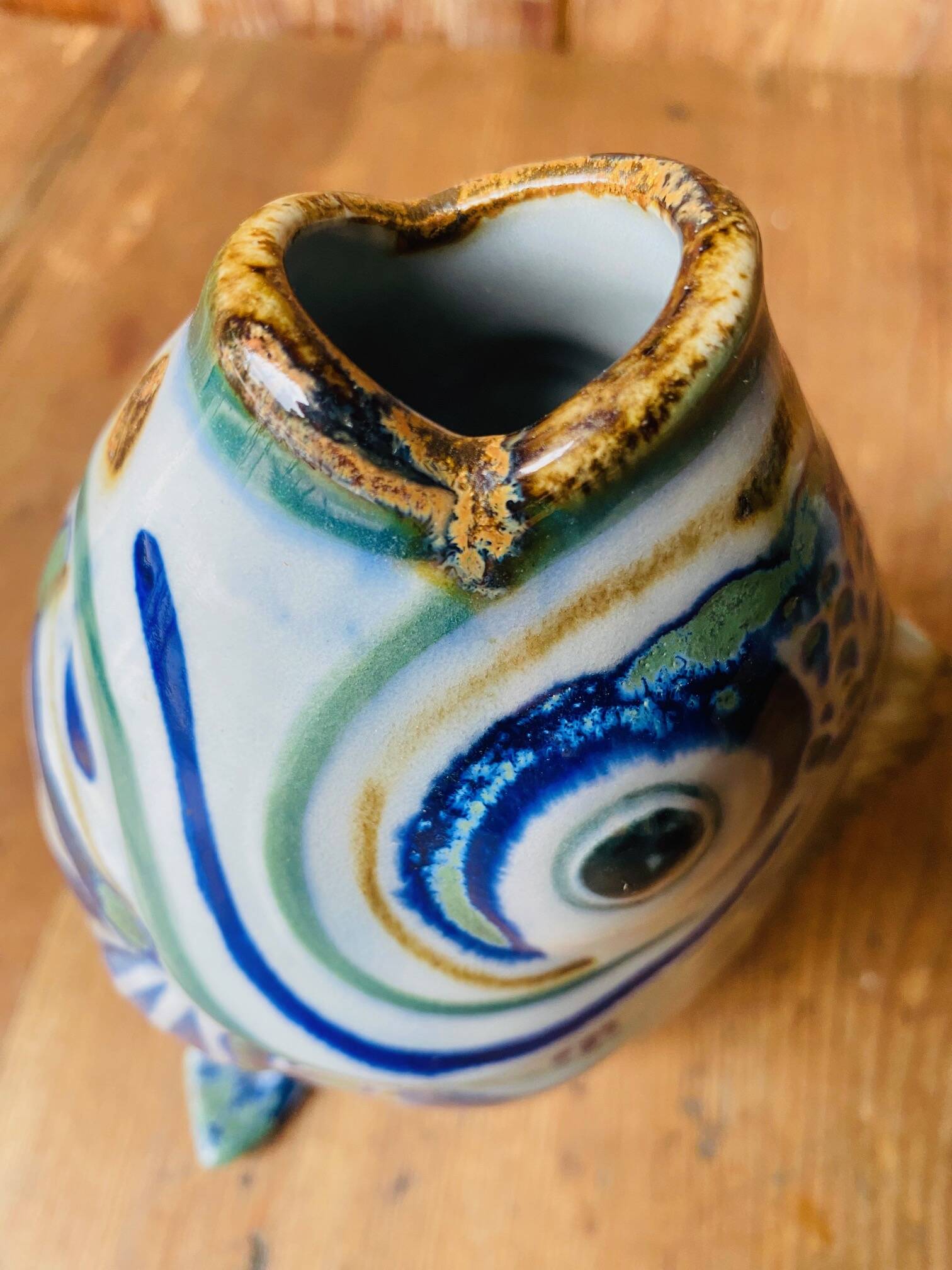 Blue ceramic zoomorphic vase in the shape of a poison.