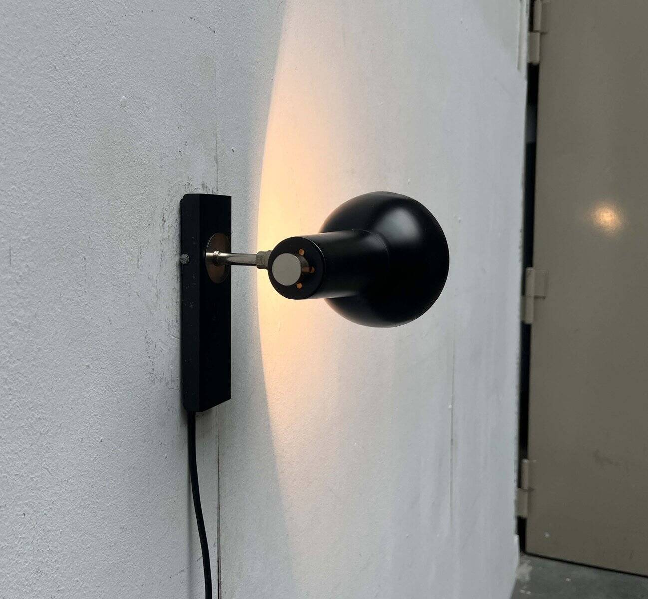 Mid-century German black minimalist wall lamp by Hustadt, 1960s.