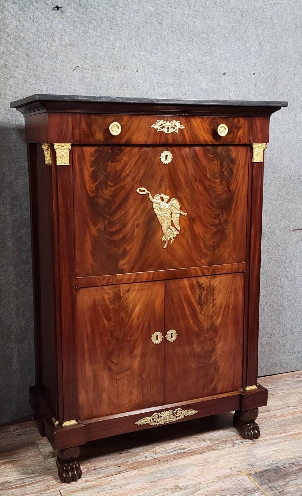 Rare four-column secretary from the Empire period in flame mahogany and bronze.