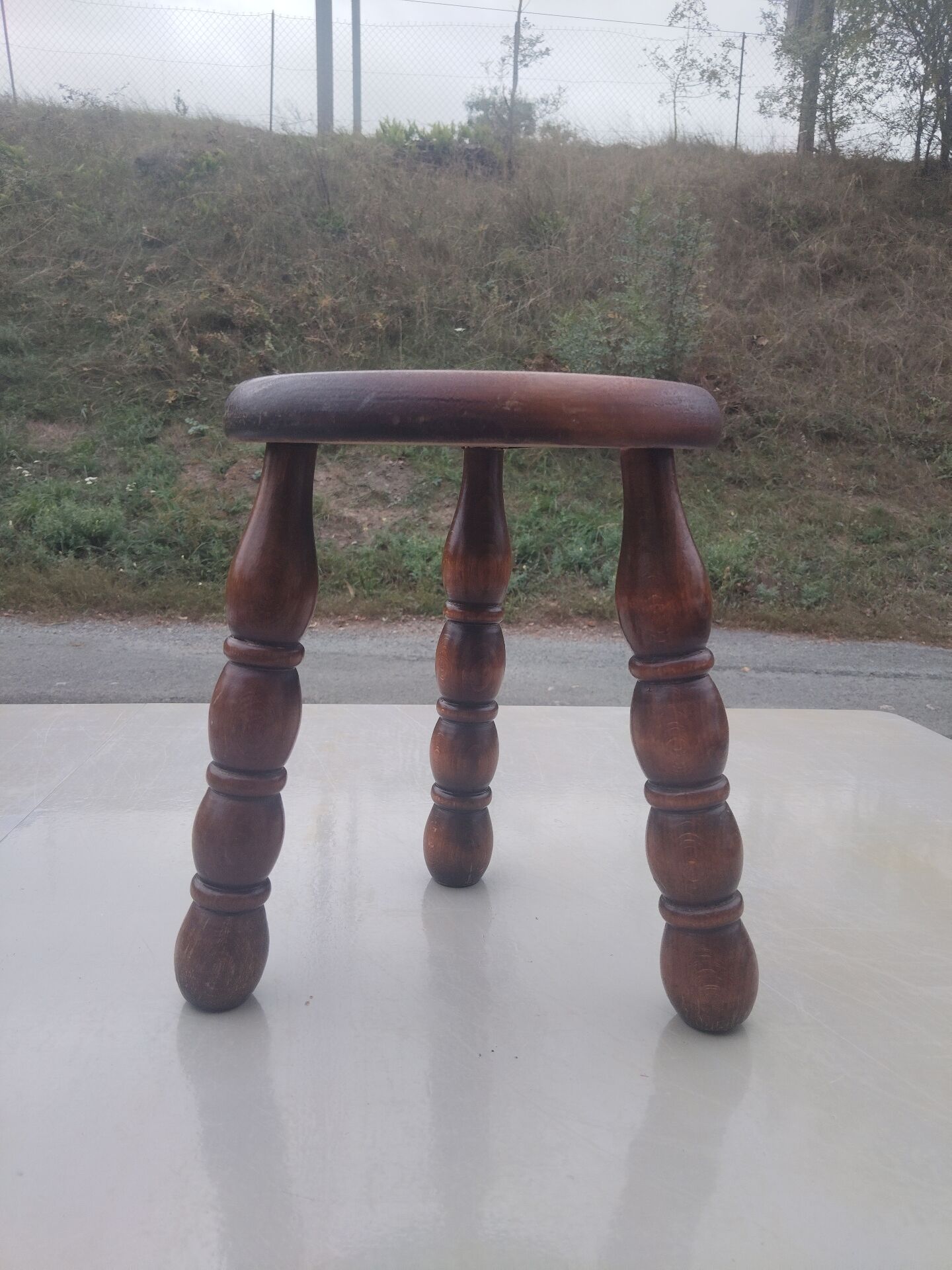 Small vintage tripod stool made of turned wood, in the style of Charles.