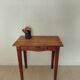 Small antique solid wood table in chic country style with a drawer.