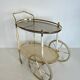 Italian oval rolling table in brass and lacquered wood.