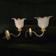 Frosted glass wall sconces and gilded brass in Art Deco style.