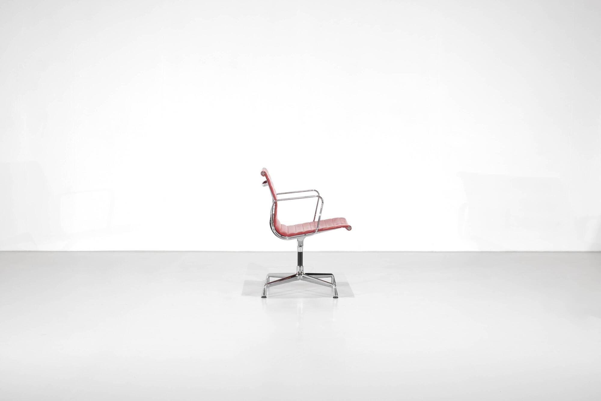 "EA 108" armchair in red leather, designed by Charles and Ray Eames for Vitra,