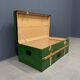 Green metal trunk with wooden sleds
