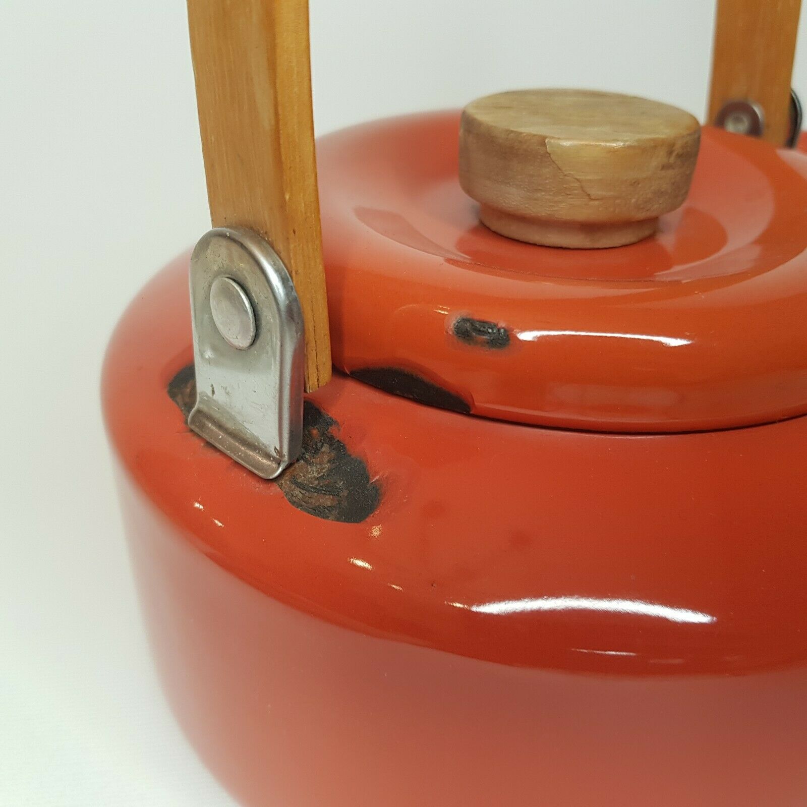 Orange and bamboo enamelled metal teapot in the 1970s