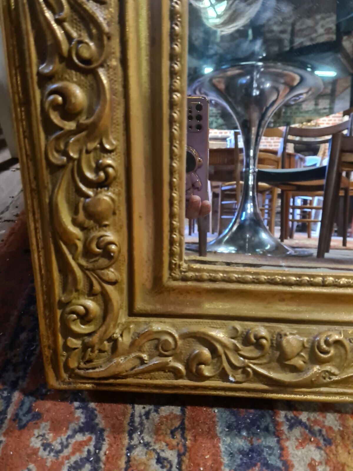 Golden mirror with a flute-playing angel