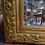 Golden mirror with a flute-playing angel