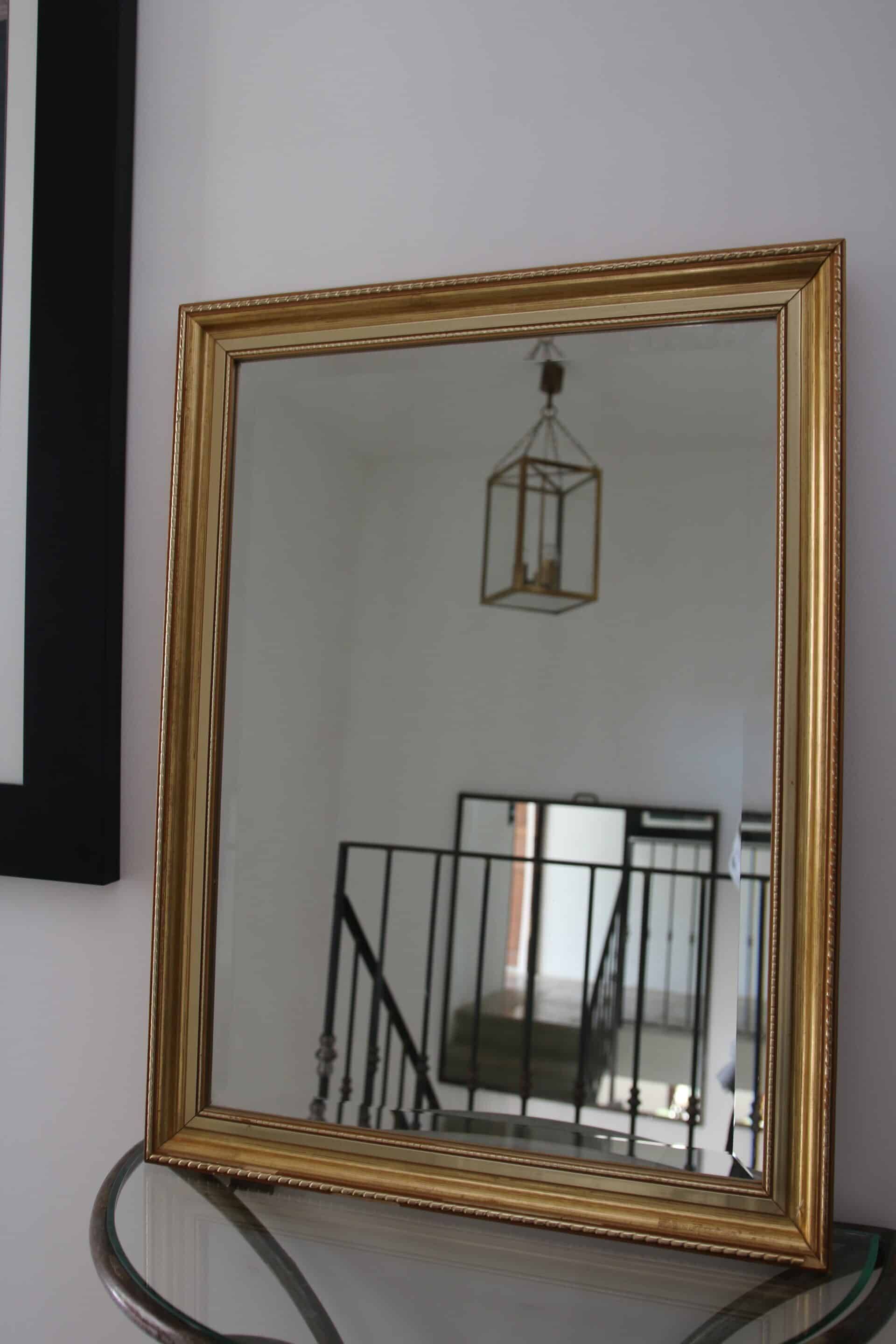 Large beveled mirror in carved wood