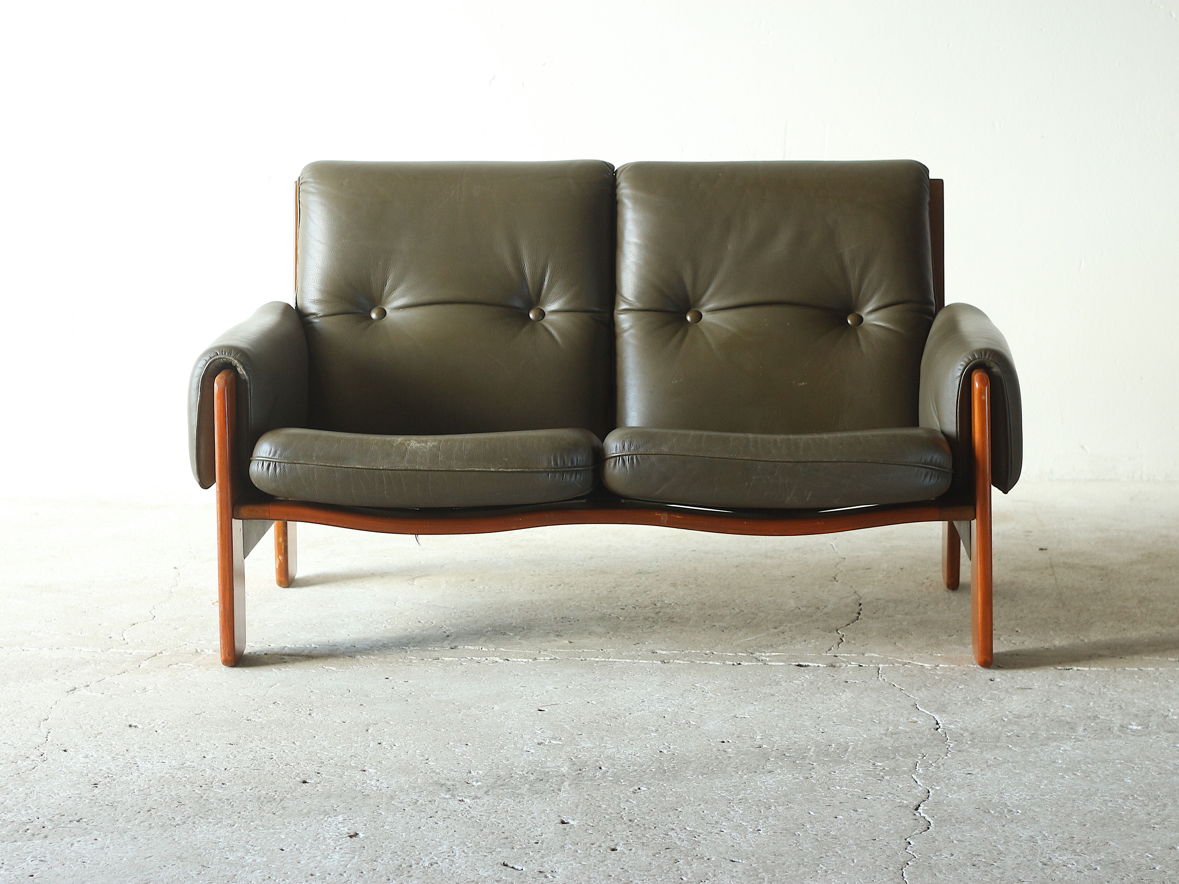 Olive leather two seater sofa, 1970'