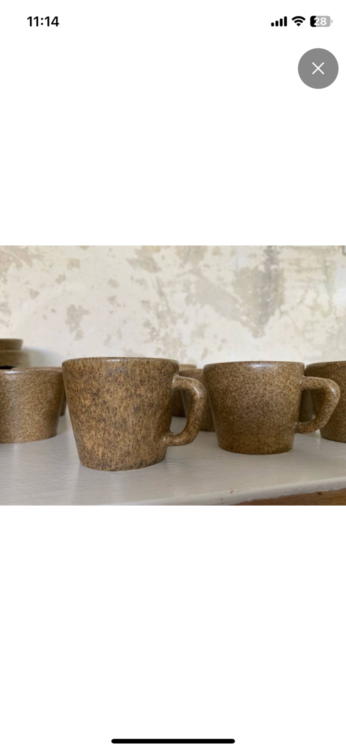 Set of stoneware coffee cups with saucers.