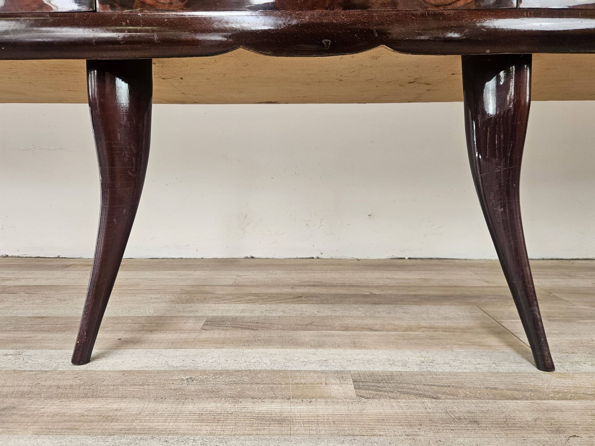 Mid-century mahogany buffet with teal glass and compartments with a drawer.