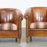 Set of 2 cognac-colored sheepskin club chairs with colorful fabric cushions