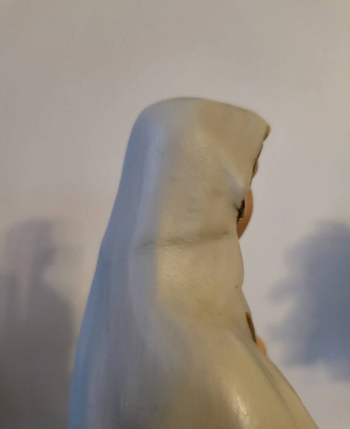 Religious statuette of the Virgin Mary in bisque porcelain