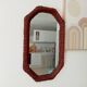 Vintage octagonal mirror in woven rattan.