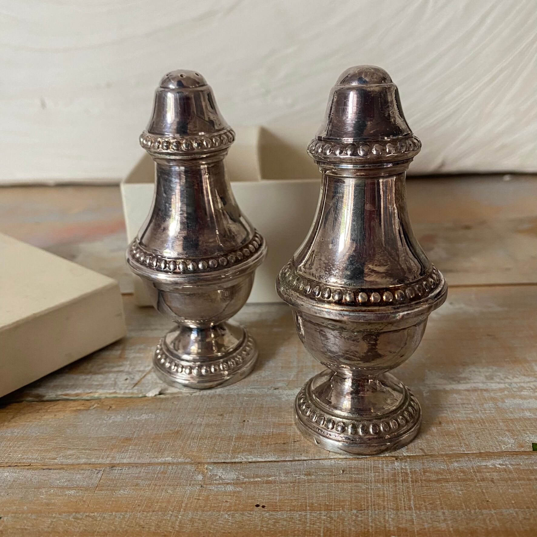 Silver-plated salt and pepper shakers, fluted, beaded decoration.