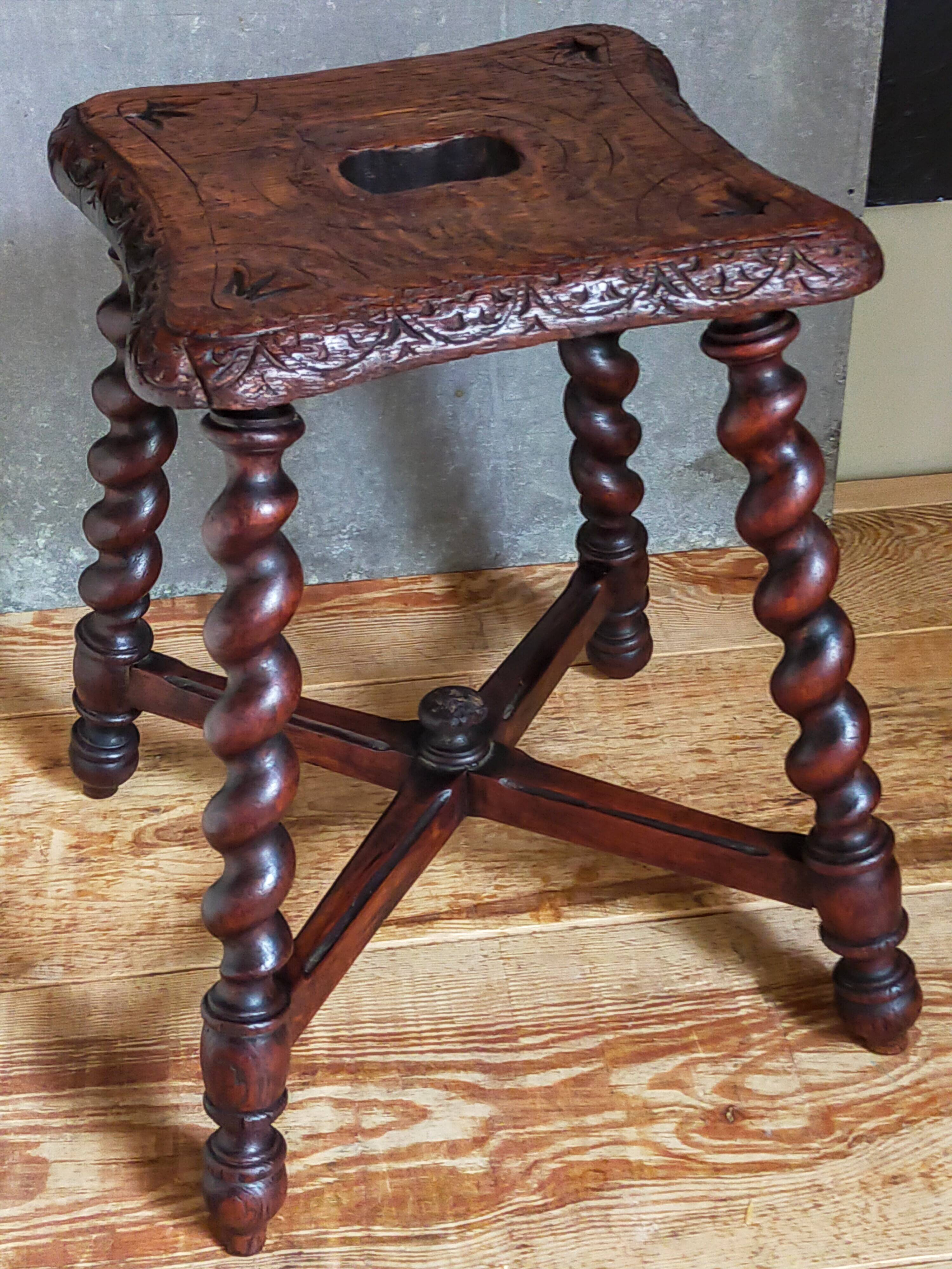 Antique stool in turned and carved solid wood