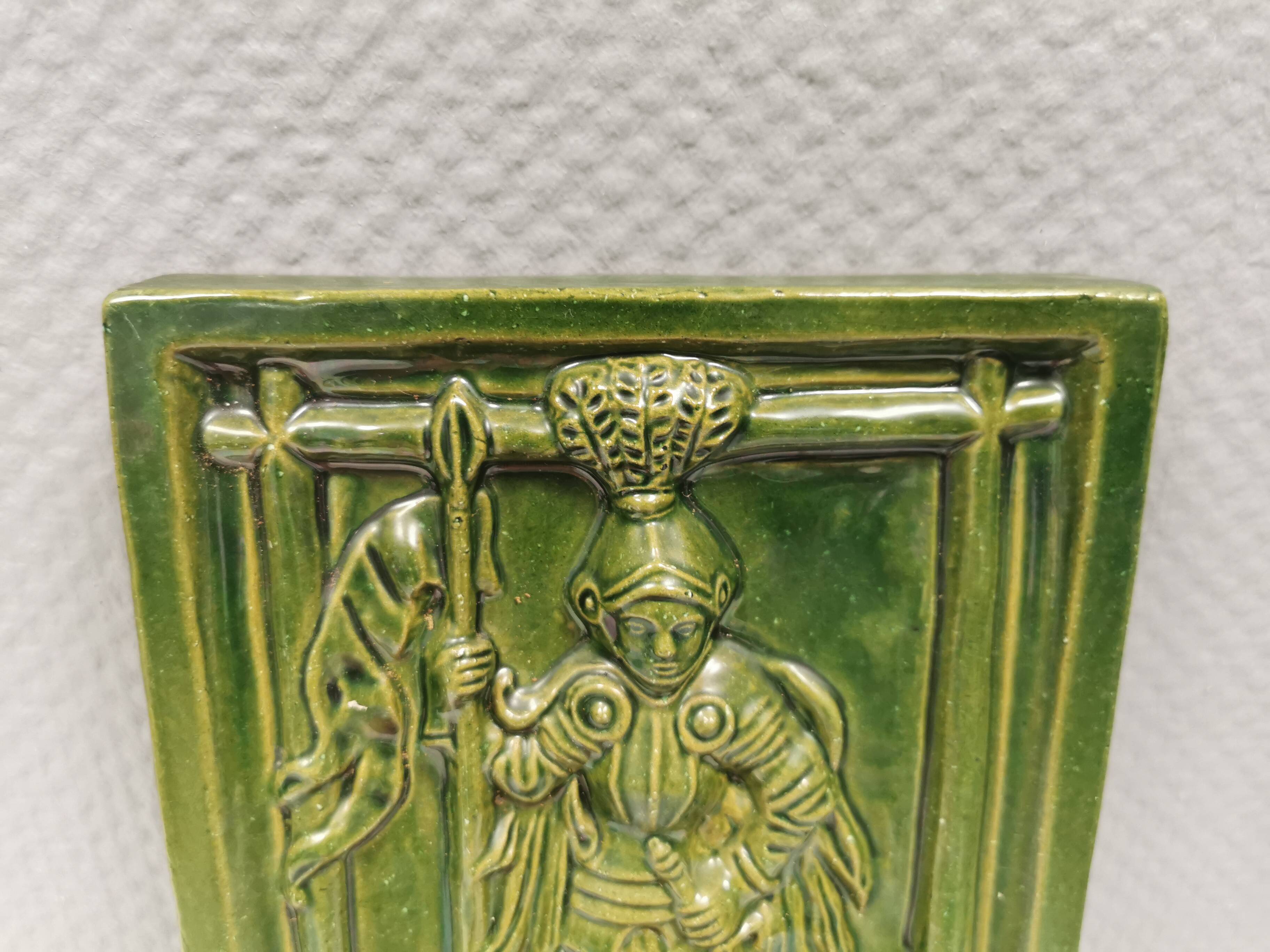 Antique tile in green faience, motif of Saint George and the dragon