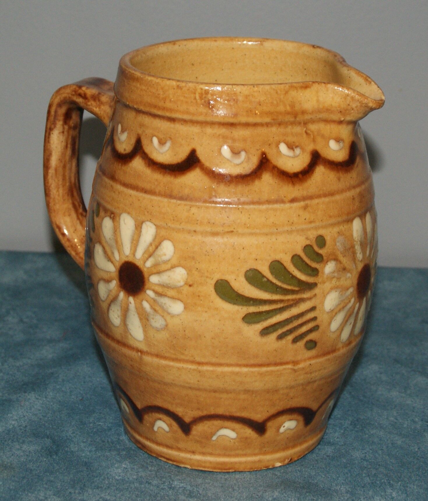Glazed terracotta pitcher decorated with friezes and flowers