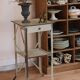 Painted metal side table, patinated white, with a drawer and two shelves
