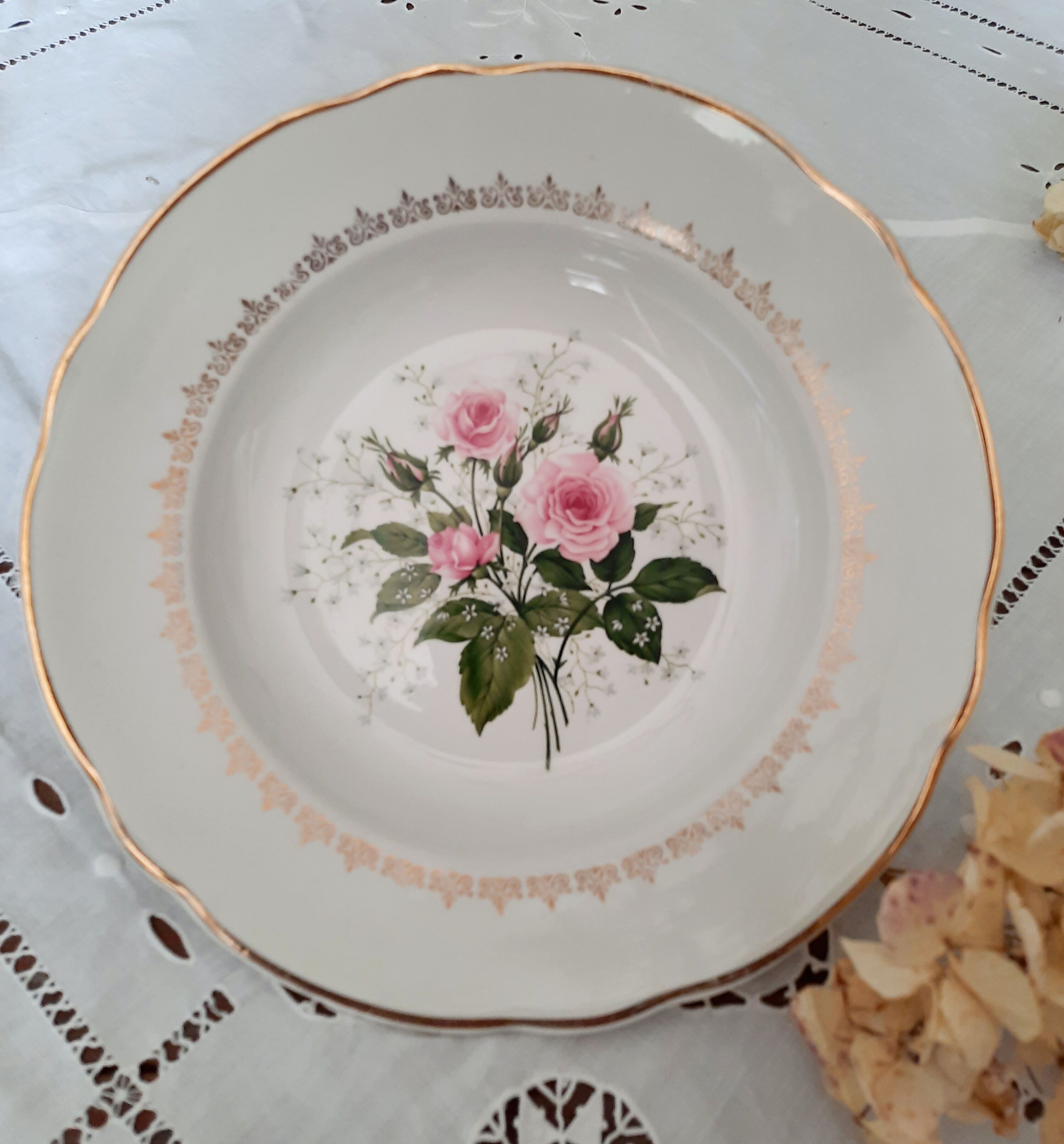 Old hollow plates mismatched in earthenware with gilded edges