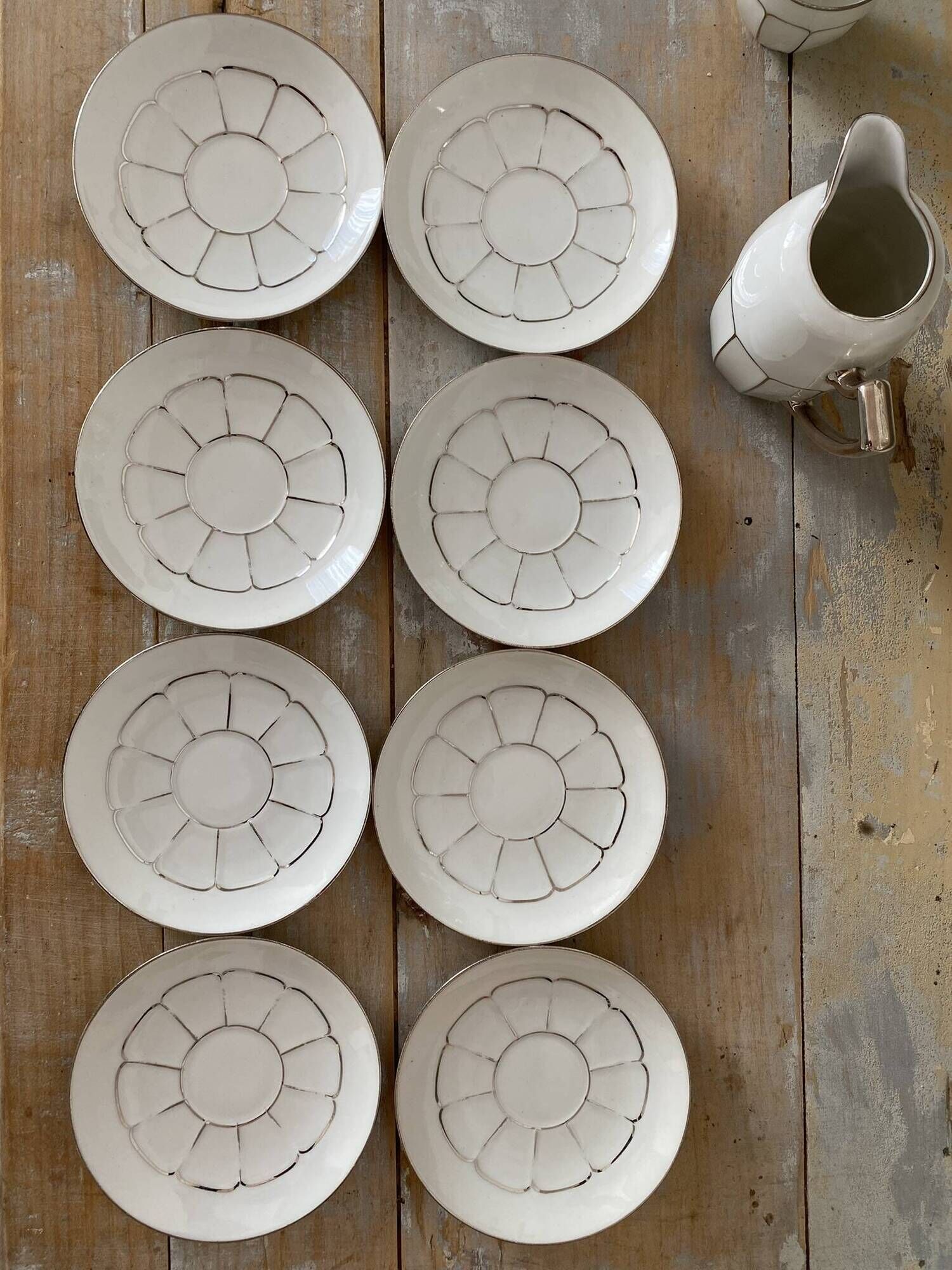 White and silver Limoges porcelain coffee cups and saucers.
