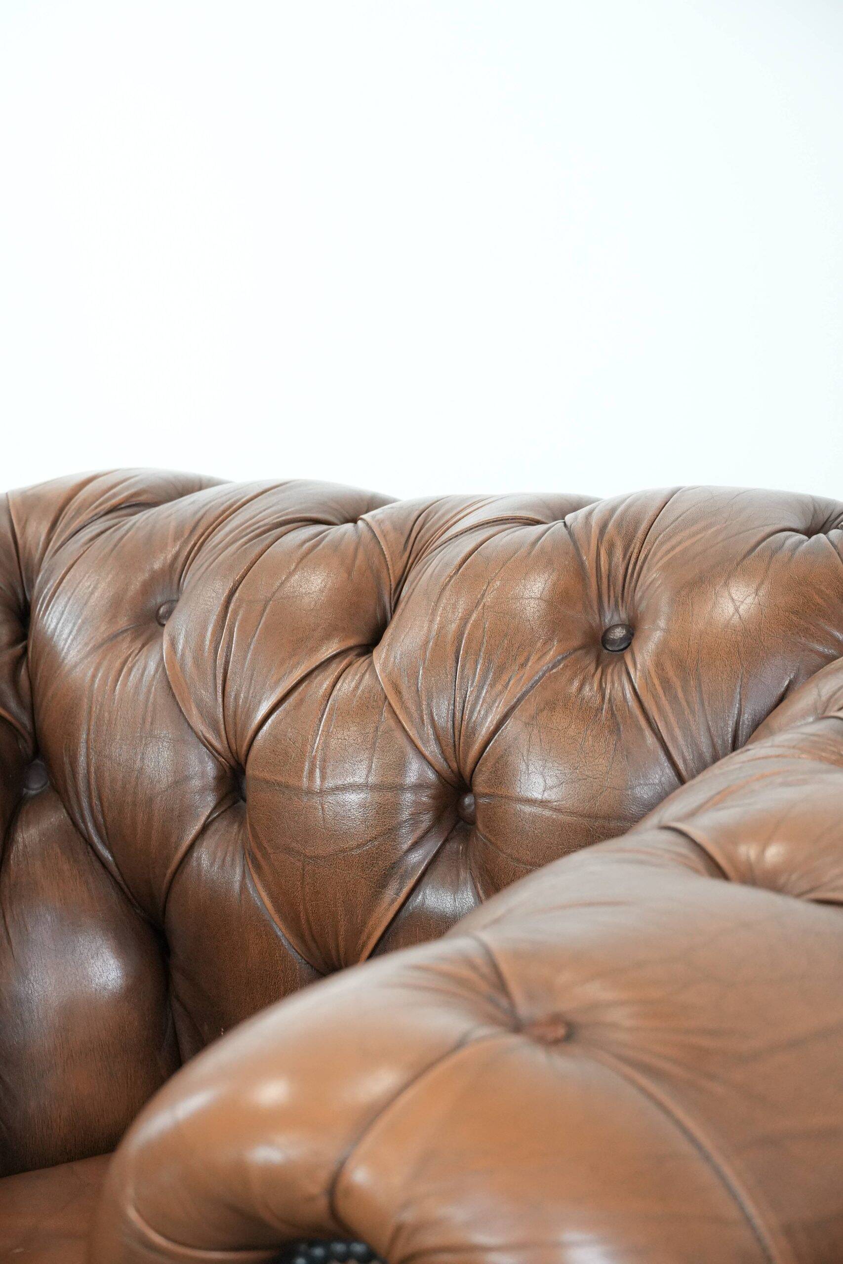 Brown cowhide leather chesterfield armchair  in English style on wheels
