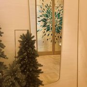 Rectangular mirror with rounded edges and a repoussé brass frame.