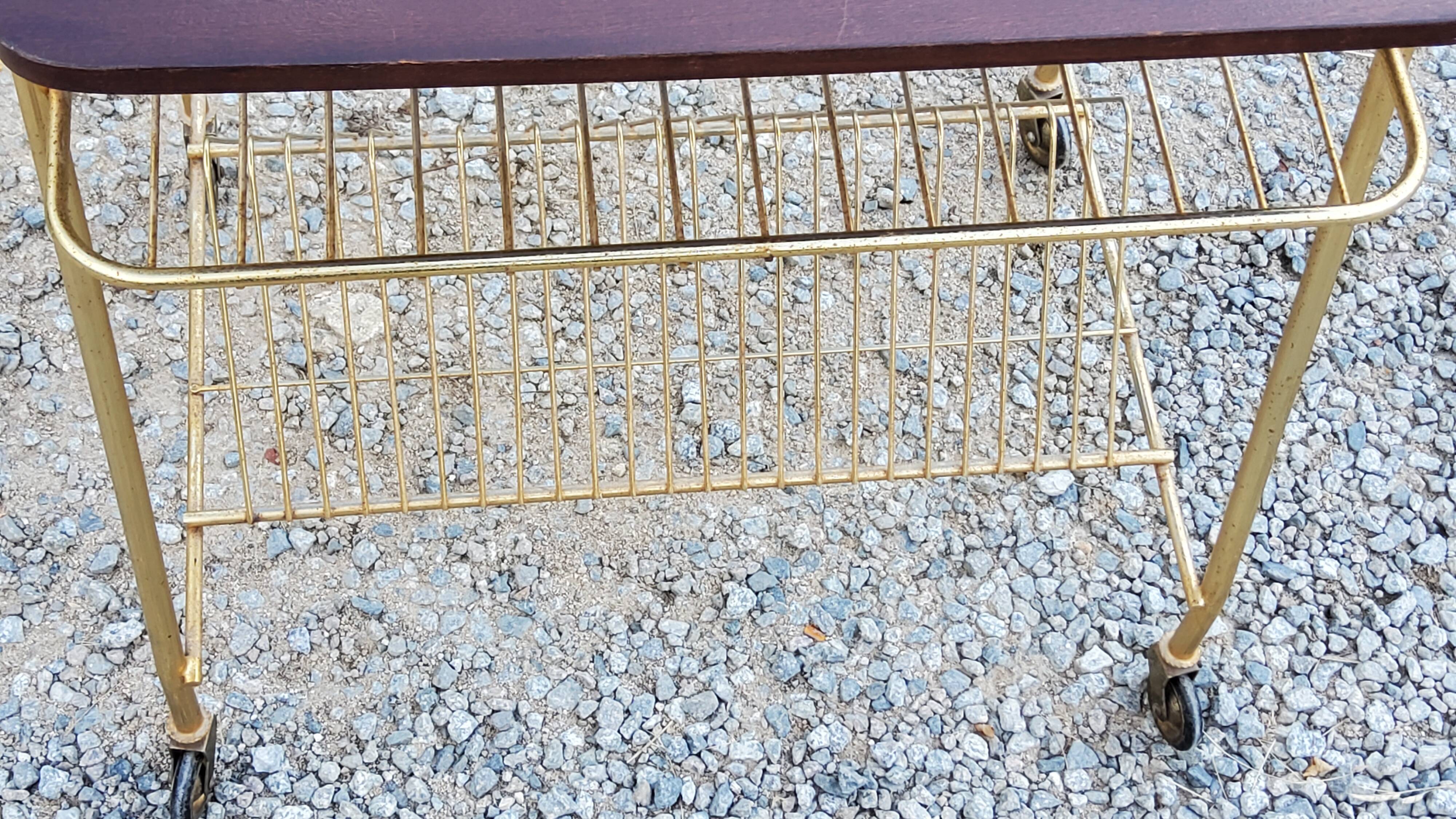 Side table of the 60s mahogany and gold metal range discs