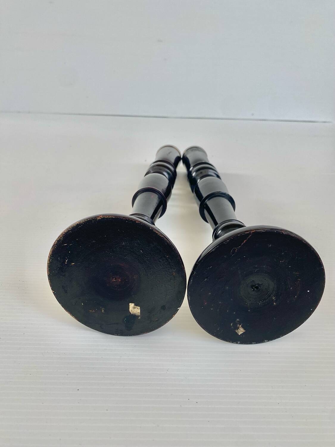 Pair of antique ebonised wooden candlesticks from the 19th century.