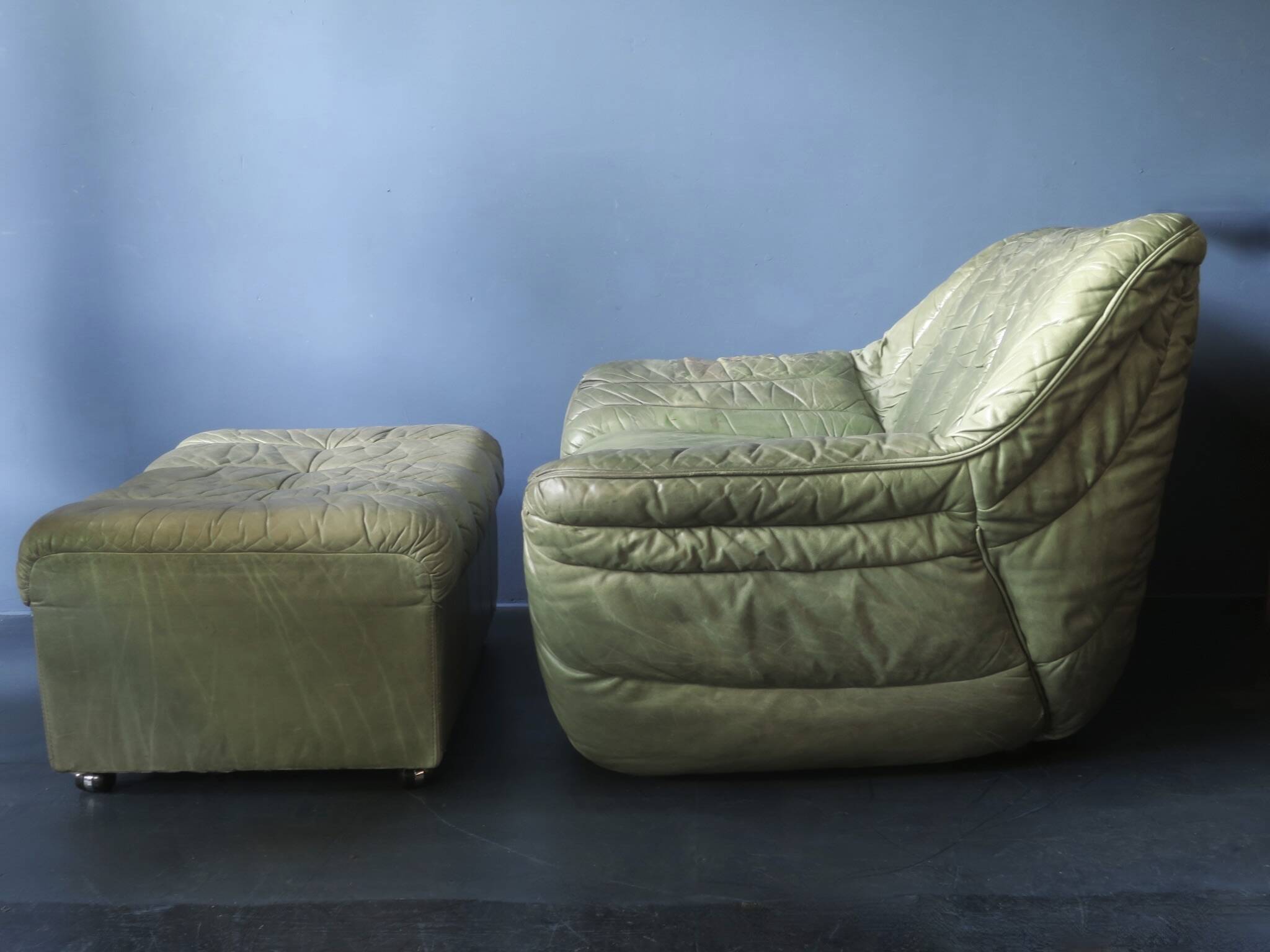 Laauser lounge chair and ottoman in olive green patchwork leather, 1970s