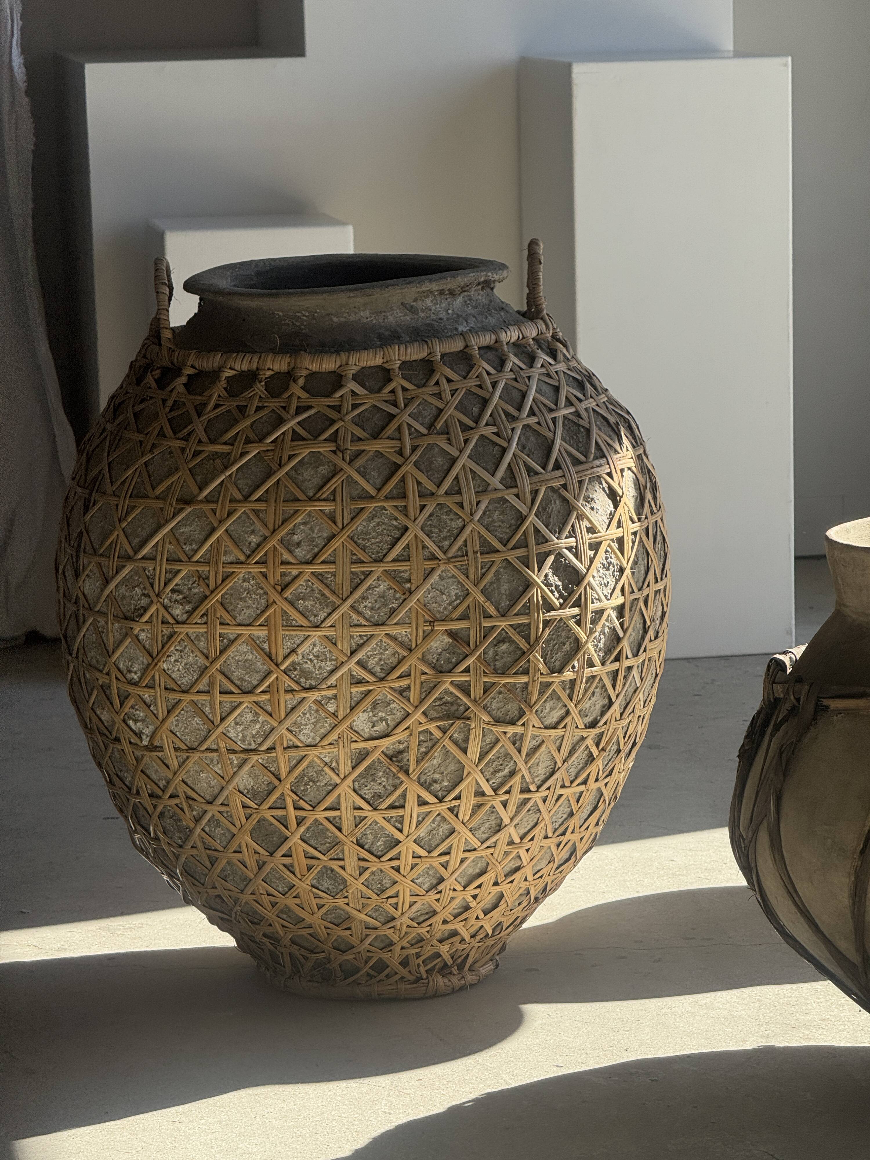 Immense light grey antique-style pot with a crosshatch lid and handles.