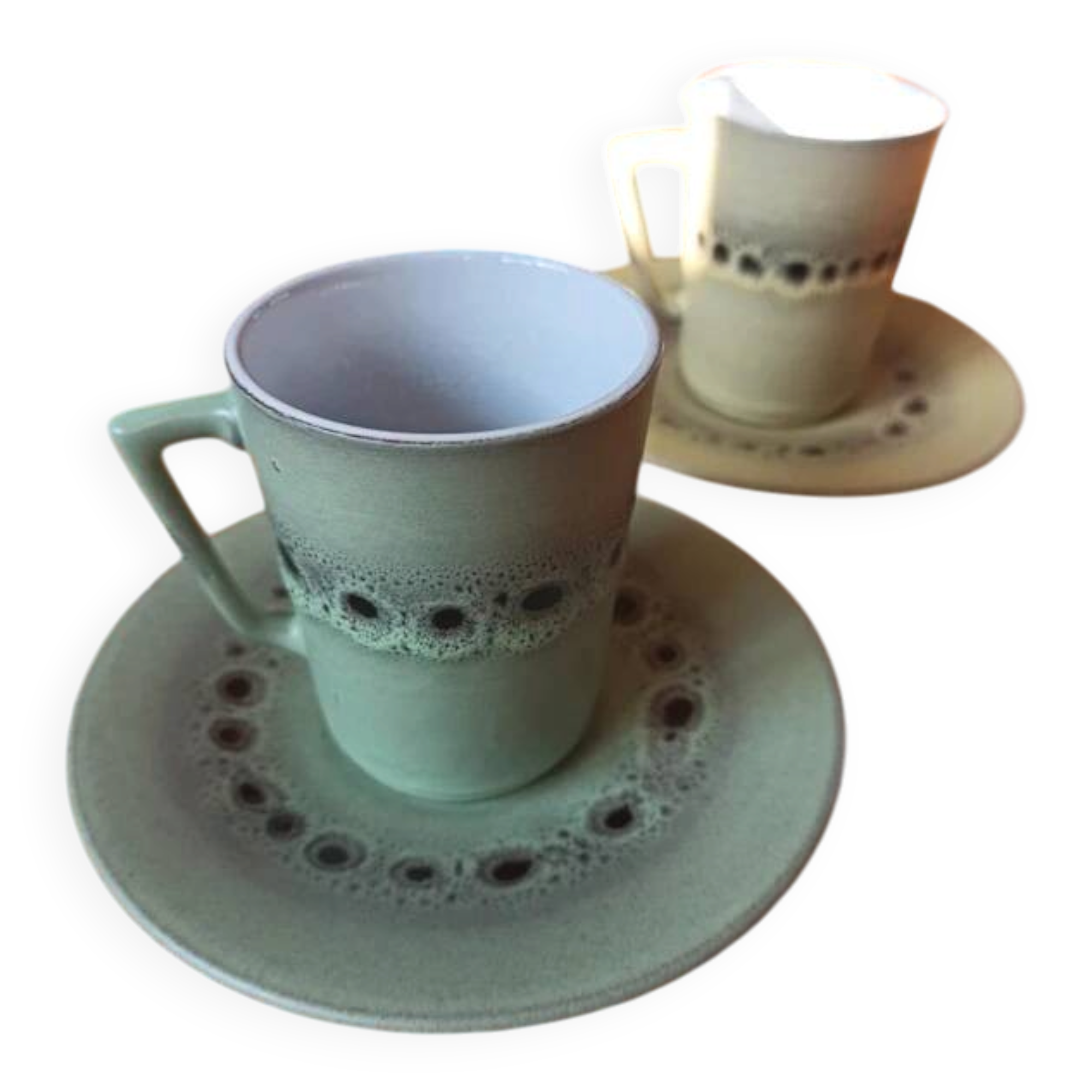 A pair of vintage glazed stoneware cups and saucers.