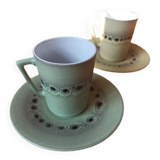 A pair of vintage glazed stoneware cups and saucers.