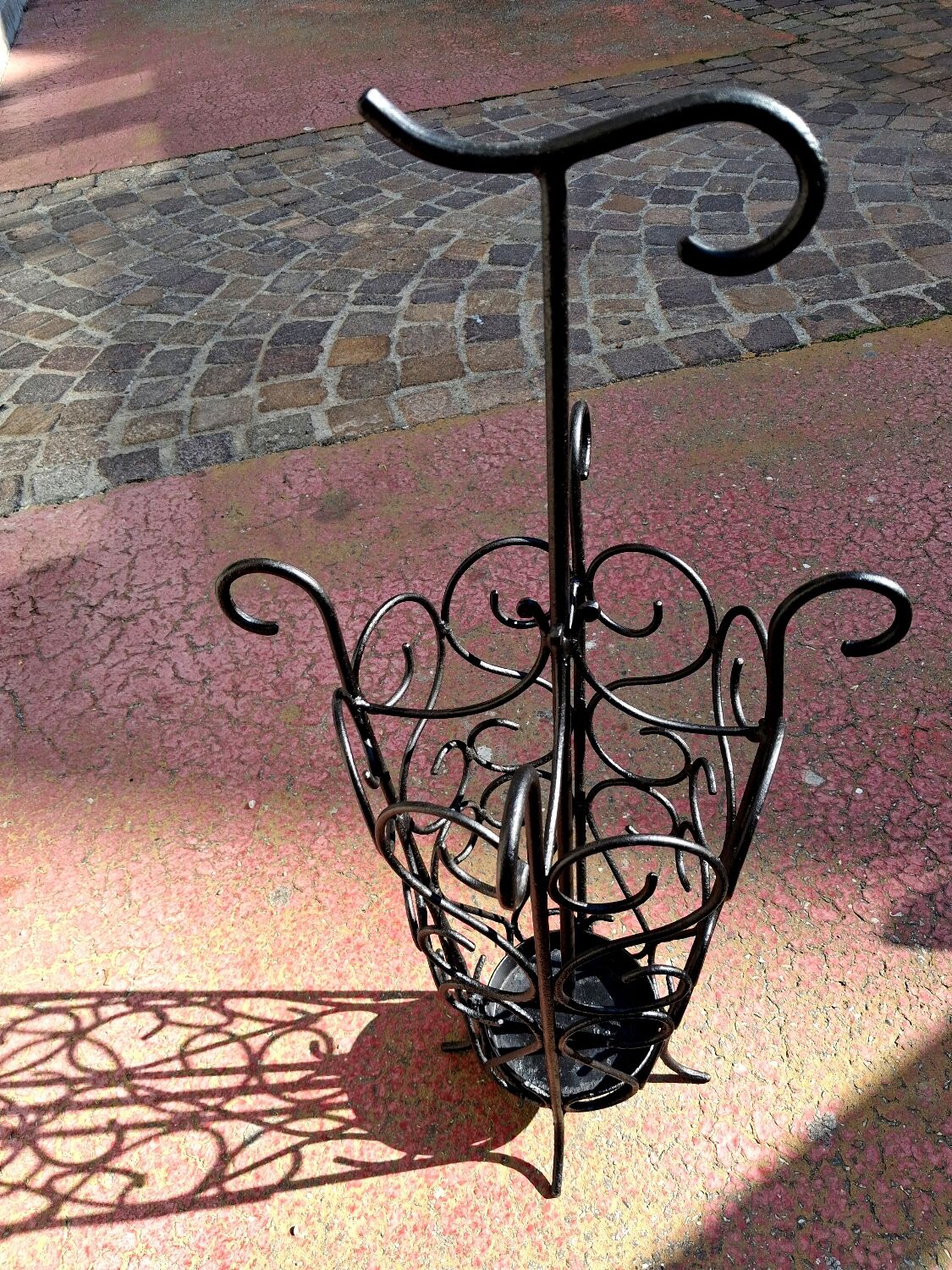 Antique wrought iron umbrella stand for entrance hall, vintage decor.