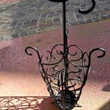 Antique wrought iron umbrella stand for entrance hall, vintage decor.