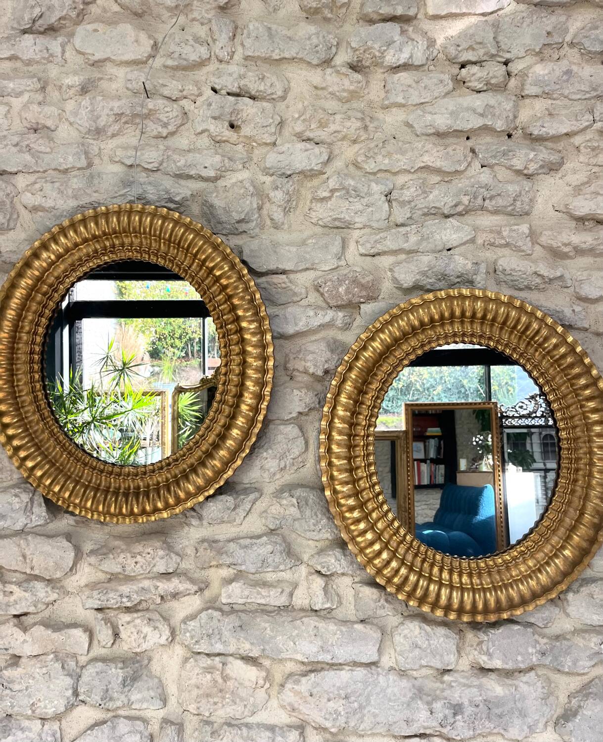 Pair of antique oval mirrors gilded with gold leaf and mercury.