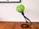 Modernist green cased glass and brass articulated table lamp