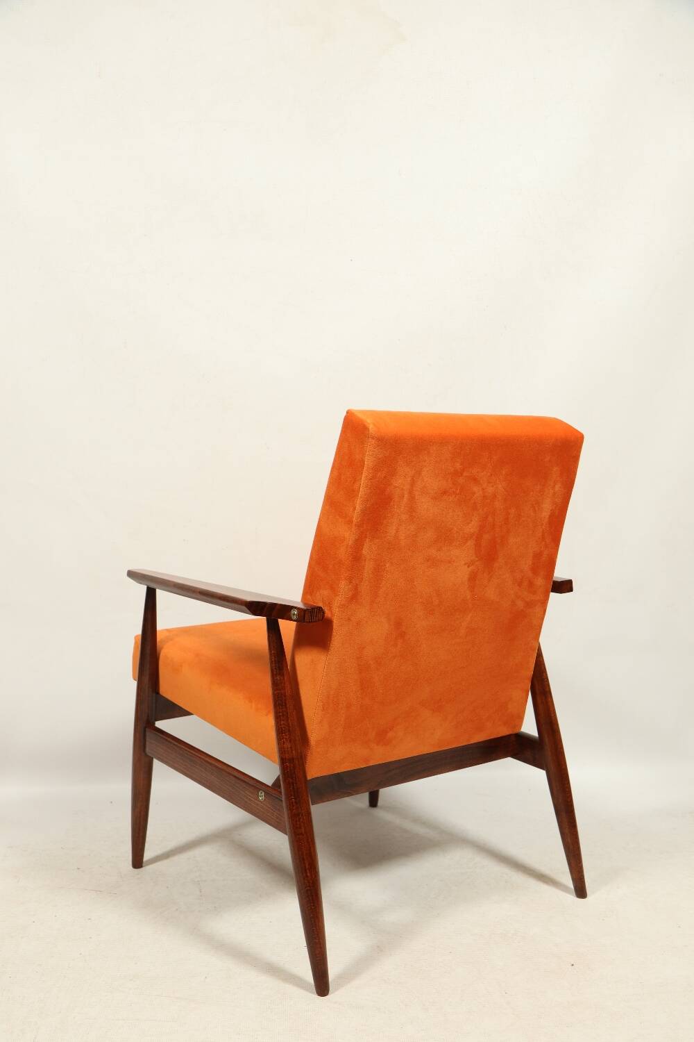 Modern armchair in orange papaya velvet with dark brown wood, 1970s Scandinavian style.