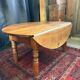 Oval drop-leaf coffee table