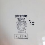 Old mismatched earthenware dinner plates accompanied by a deep dish